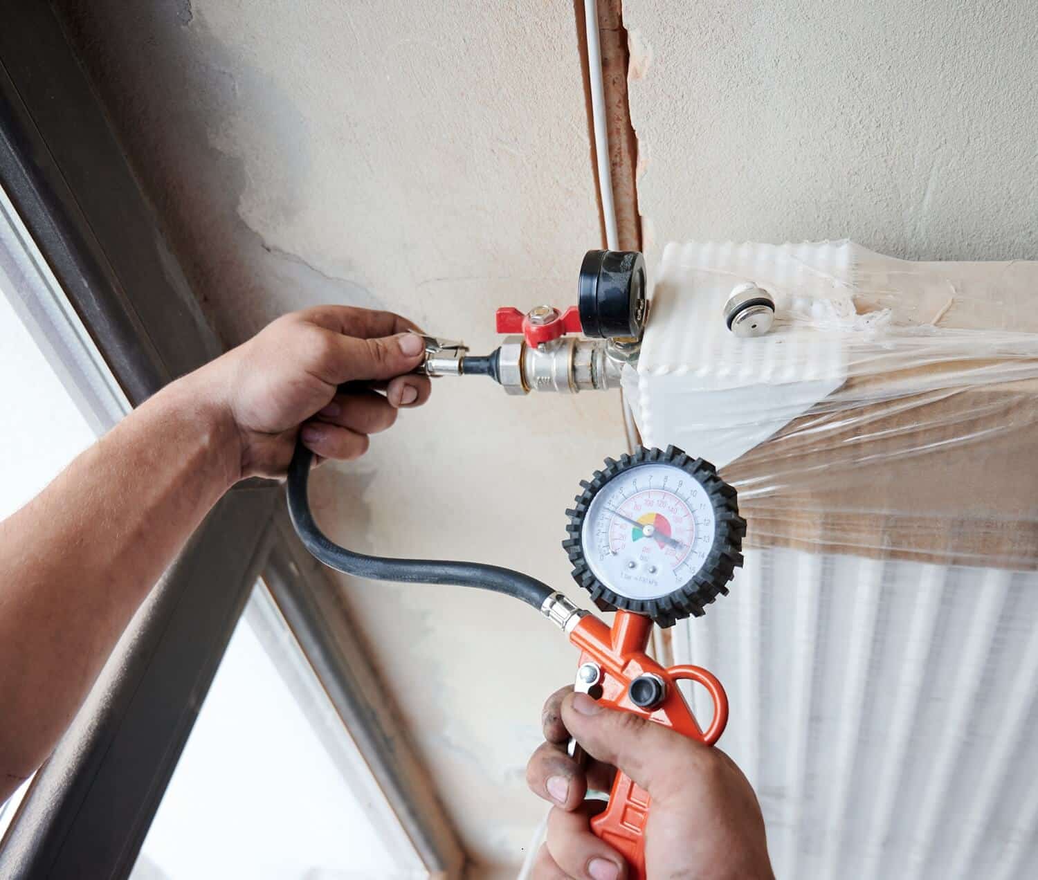 Pressure Testing Gas Lines plumber filling pipes with pressurized air to inspect for leaks